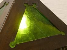 Load image into Gallery viewer, Close-up of a triangular green glass panel set within a dark brown wooden frame, with a bright light reflecting off the glossy surface.
