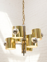 Load image into Gallery viewer, Vintage Space Age chandelier with polished brass cylindrical shades, mirrored chrome spheres, multiple lights, and chain suspension