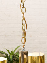 Load image into Gallery viewer, Vintage Space Age chandelier with polished brass cylindrical shades, mirrored chrome spheres, multiple lights, and chain suspension