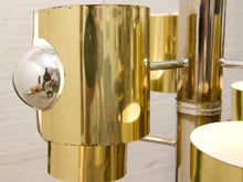 Load image into Gallery viewer, Vintage Space Age chandelier with polished brass cylindrical shades, mirrored chrome spheres, multiple lights, and chain suspension
