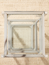 Load image into Gallery viewer, A square mirrored wall mirror with a silver-toned metal frame, photographed from directly above on a textured beige woven rug.