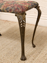 Load image into Gallery viewer, Close-up of an antique-style stool with carved dark brown wooden cabriole legs and a floral patterned fabric seat cushion, shown on a woven rug.