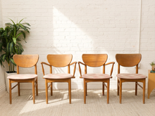 Load image into Gallery viewer, Set of four vintage Mid-Century wood dining chairs with curved backrests, tapered legs, faded upholstered seats, and two chairs with arms