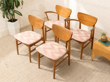 Load image into Gallery viewer, Set of four vintage Mid-Century wood dining chairs with curved backrests, tapered legs, faded upholstered seats, and two chairs with arms