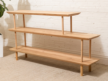 Load image into Gallery viewer, Vintage three-tier natural wood display shelf with long staggered shelves, rounded edges, slender dowel supports, and visible wood grain