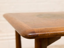Load image into Gallery viewer, Close-up of a wooden table corner with rounded edges and a glossy finish, showing the wood grain and a small circular inset detail on the tabletop.