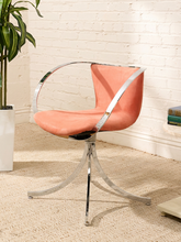 Load image into Gallery viewer, Vintage 1970s chrome halo swivel armchair with blush pink velvet upholstery, curved chrome arms, and four-prong pedestal base