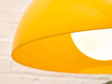 Load image into Gallery viewer, Close-up of a glossy bright yellow dome-shaped lamp shade against a white brick wall background.