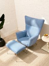 Load image into Gallery viewer, Vintage blue upholstered high-back lounge chair with angular padded arms, slender metal legs, and matching ottoman