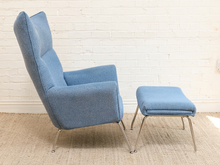 Load image into Gallery viewer, Vintage blue upholstered high-back lounge chair with angular padded arms, slender metal legs, and matching ottoman