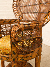 Load image into Gallery viewer, A close-up of a woven rattan armchair with a tall backrest, featuring dark brown geometric patterned accents and a yellow patterned cushion.