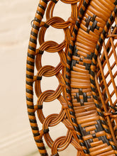 Load image into Gallery viewer, Close-up of a woven rattan chair back showing interlaced brown and black wicker strands in a circular lattice pattern.