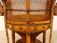 Load image into Gallery viewer, Close-up of a woven rattan chair back and seat, showing a warm tan and brown wicker pattern with black geometric accents and a cushion inside.