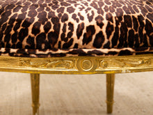 Load image into Gallery viewer, Close-up of an upholstered stool or bench with a leopard-print fabric seat and an ornate gold frame.