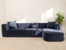 Load image into Gallery viewer, Bonnie three-piece sectional sofa in Amici Indigo blue upholstery with left-arm-facing loveseat, armless section, right-arm-facing chaise, and loose pillows