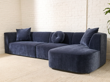 Load image into Gallery viewer, Bonnie three-piece sectional sofa in Amici Indigo blue upholstery with left-arm-facing loveseat, armless section, right-arm-facing chaise, and loose pillows