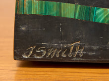 Load image into Gallery viewer, Close-up of a dark carved wooden box or block with a green malachite inlay band and the name 'JSmith' carved into the side, resting on a wooden surface.