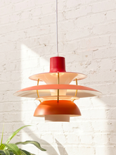 Load image into Gallery viewer, Modern red sculptural pendant light with layered circular disc shades and cylindrical central housing