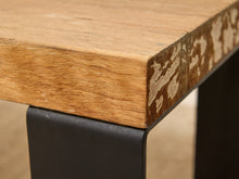 Load image into Gallery viewer, Close-up of a rustic wooden table corner with a natural oak top and a black metal leg.