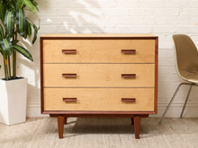Load image into Gallery viewer, Birdseye maple lowboy dresser with three wide drawers, contrasting warm wood trim, rectangular wood pulls, and tapered legs