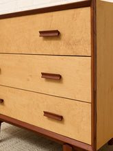 Load image into Gallery viewer, A close-up of a mid-century modern three-drawer dresser with light natural wood drawer fronts and a darker reddish-brown wood frame and handles.
