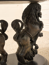 Load image into Gallery viewer, Close-up of a dark bronze lion statue with a highly detailed mane and muscular body, standing on a pedestal next to another partially visible lion figure.