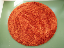 Load image into Gallery viewer, Vintage round shag rug with thick high-pile texture in burnt orange, rust, red, and warm earthy tones