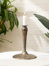 Load image into Gallery viewer, Vintage silver-tone candlestick holder with slender tapered stem, flared candle cup, broad round base, and aged patina