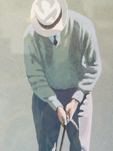 Load image into Gallery viewer, The Putt framed golf art print depicting a golfer lining up a putt, with neutral matting and a warm wood frame