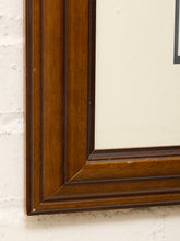 Load image into Gallery viewer, Close-up of a dark brown wooden picture frame corner mounted against a white textured wall.
