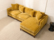 Load image into Gallery viewer, Lisette Sofa with Chaise in Sacramento Honey featuring golden mustard upholstery, plush seat cushions, coordinating pillows, wide arms, and wood legs
