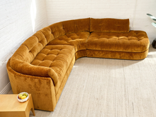 Load image into Gallery viewer, Prima curved sectional sofa in Thriller Amber with golden amber upholstery, deep button-tufted seats, channel-tufted back cushions, and rounded silhouette