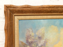 Load image into Gallery viewer, Close-up of a framed painting showing a textured medium brown wooden frame with a gold inner border and a soft pastel landscape painting in blue, yellow, and purple tones.
