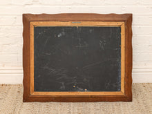Load image into Gallery viewer, An antique wooden writing board with a dark chalkboard center and a warm brown wooden frame, leaning against a white brick wall on a beige woven rug.
