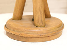 Load image into Gallery viewer, Close-up of a wooden stool base with three cylindrical legs and a round wooden seat, shown on a white surface.