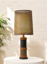 Load image into Gallery viewer, Vintage table lamp with tall brown woven shade, black cylindrical base, warm wood accents, and wrapped textured detailing
