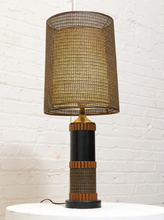 Load image into Gallery viewer, Vintage table lamp with tall brown woven shade, black cylindrical base, warm wood accents, and wrapped textured detailing