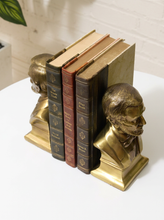 Load image into Gallery viewer, Pair of vintage brass Abraham Lincoln bust bookends with detailed profiles, period clothing, warm patina, and stepped bases