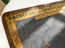 Load image into Gallery viewer, A close-up of a vintage-style reading/writing alphabet board with a distressed yellow border and black lettering on a white surface.