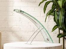 Load image into Gallery viewer, Vintage 1970s sculptural table lamp with elongated curved clear glass body, green-tinted glass edges, slender metal supports, and an arched silhouette