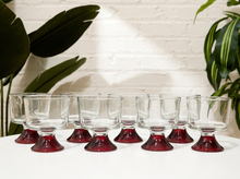 Load image into Gallery viewer, Set of eight vintage smoky clear glass tumblers with rounded bowls and contrasting ruby red pedestal bases