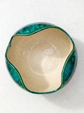 Load image into Gallery viewer, A handmade ceramic bowl viewed from above, featuring a glossy teal-green marbled exterior and a warm beige glazed interior.