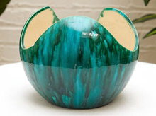 Load image into Gallery viewer, A handmade ceramic bowl with a glossy teal and green marbled pattern, featuring three flared openings, shown on a white surface with a neutral background.