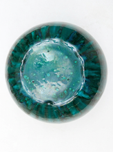 Load image into Gallery viewer, A round glass bowl with a marbled teal and green pattern, photographed from directly above on a white background.