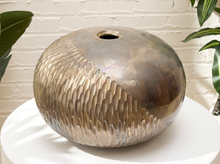 Load image into Gallery viewer, Raku-style rounded ceramic vase with textured overlapping relief pattern, small circular opening, and metallic bronze-toned finish