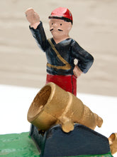 Load image into Gallery viewer, A small painted figurine of a soldier standing behind a cannon, photographed close up against a light neutral background.