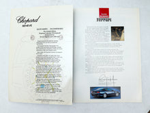 Load image into Gallery viewer, An open vintage Chopard Ferrari limited edition booklet or brochure, showing two printed pages side-by-side on a light textured background. The left page features elegant black script reading 'Chopard GENEVE' and a circular dial illustration, while the right page displays the 'Inside HONOR Ferrari' title, descriptive text, a small inset photo, and a color photo of a dark blue sports car at the bottom.