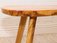 Load image into Gallery viewer, Vintage live edge wood side table with irregular natural wood tabletop, honey-brown grain, visible knots, and three tapered wooden legs