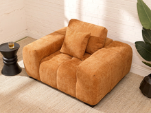 Load image into Gallery viewer, Felipe modern lounge chair in warm terracotta textured upholstery with deep channel-tufted seat, oversized padded arms, rounded silhouette, and coordinating cushions