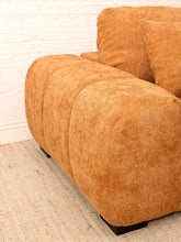Load image into Gallery viewer, Felipe modern lounge chair in warm terracotta textured upholstery with deep channel-tufted seat, oversized padded arms, rounded silhouette, and coordinating cushions